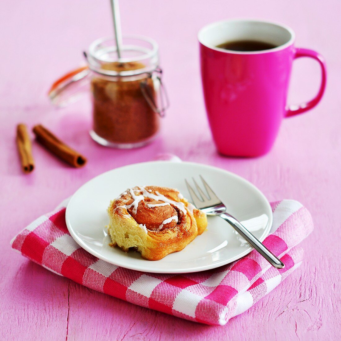 A cinnamon roll served with tea