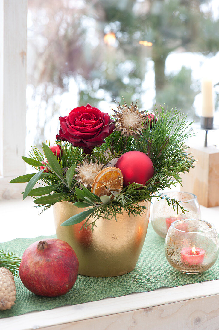 Advent arrangement with pink, twigs of Pinus