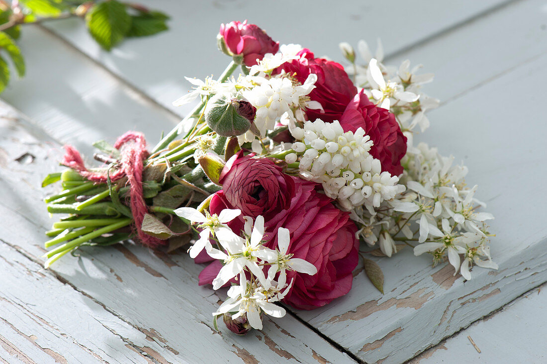 Small bouquet of Ranunculus, twigs of Amelanchier