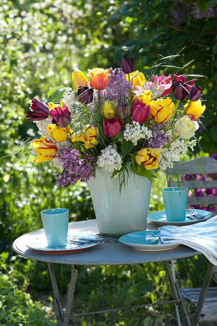 Lush syringa vulgaris and mixed tulipa bouquet