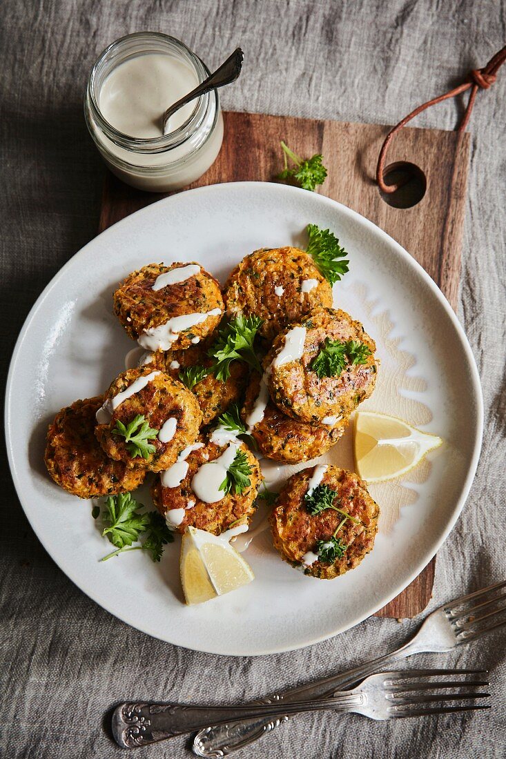 Carrot patties with ginger, herbs and drizzled lemon tahini dressing