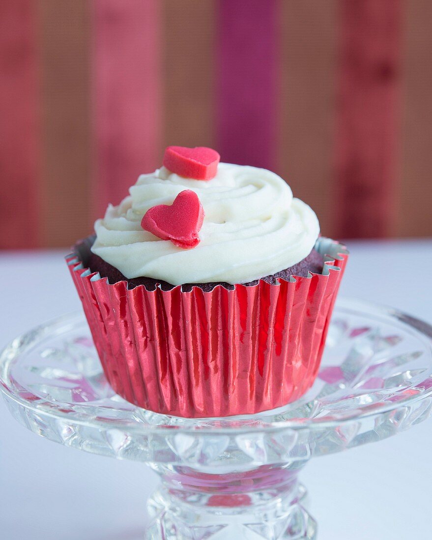 A cupcake with a red sugar heart