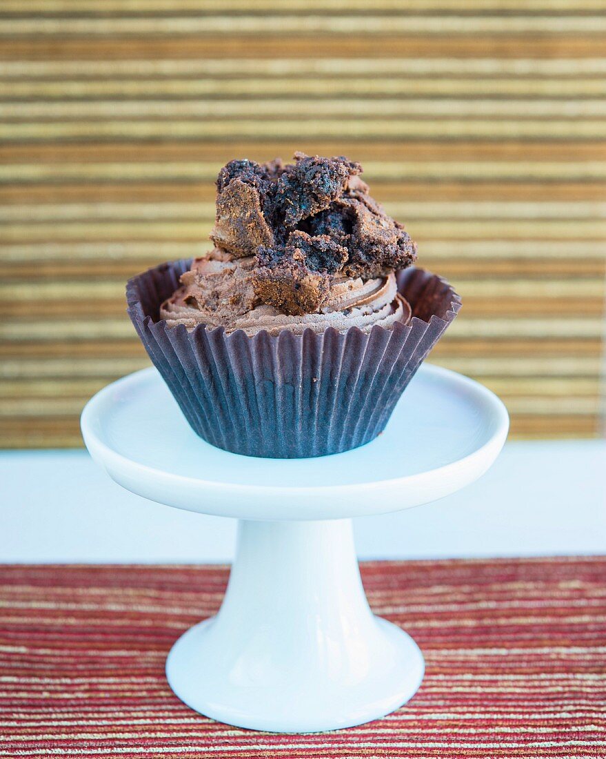 A cupcake topped with chocolate cake