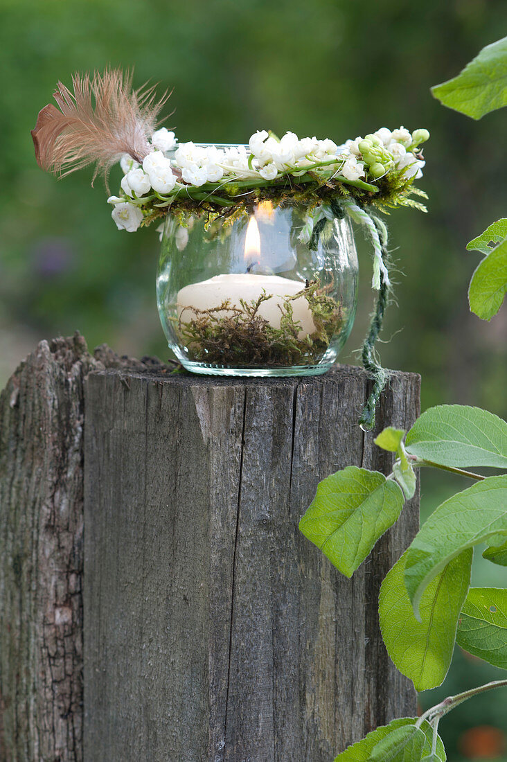 Small wreath made of Convallaria majalis (lily of the valley) with feather