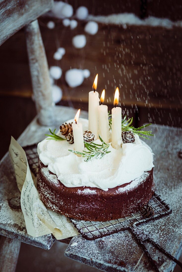 Christmas chocolate cake with lit candles