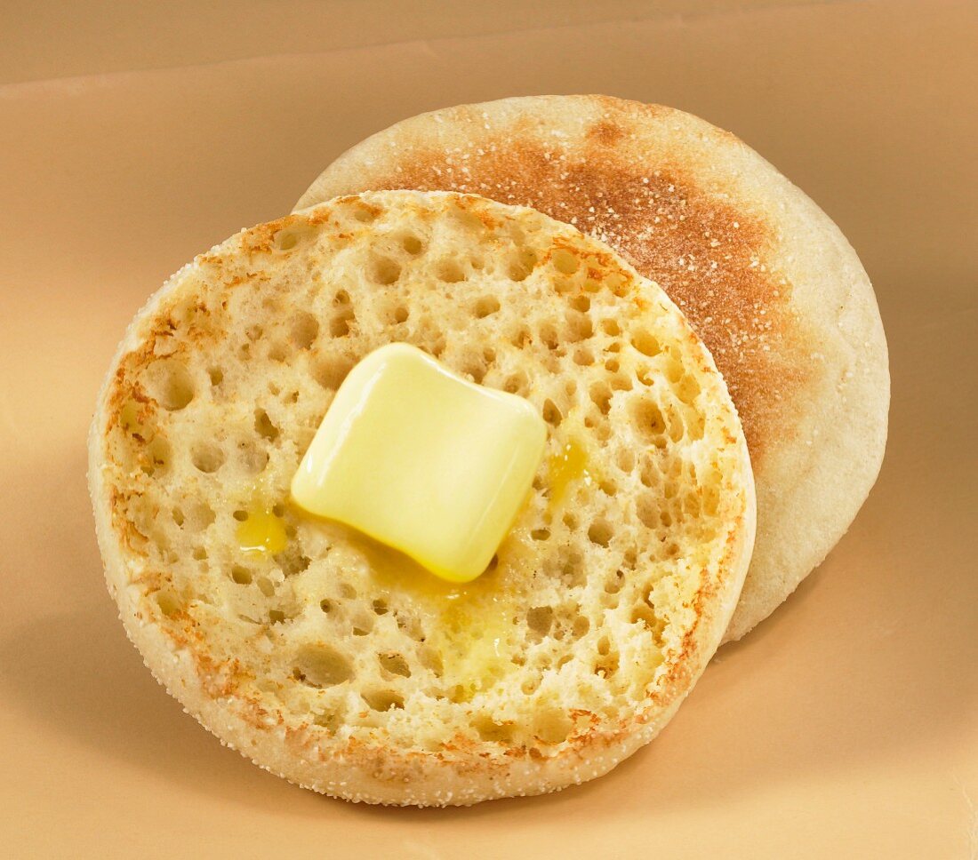 Halved and Buttered English Muffin on a Plate