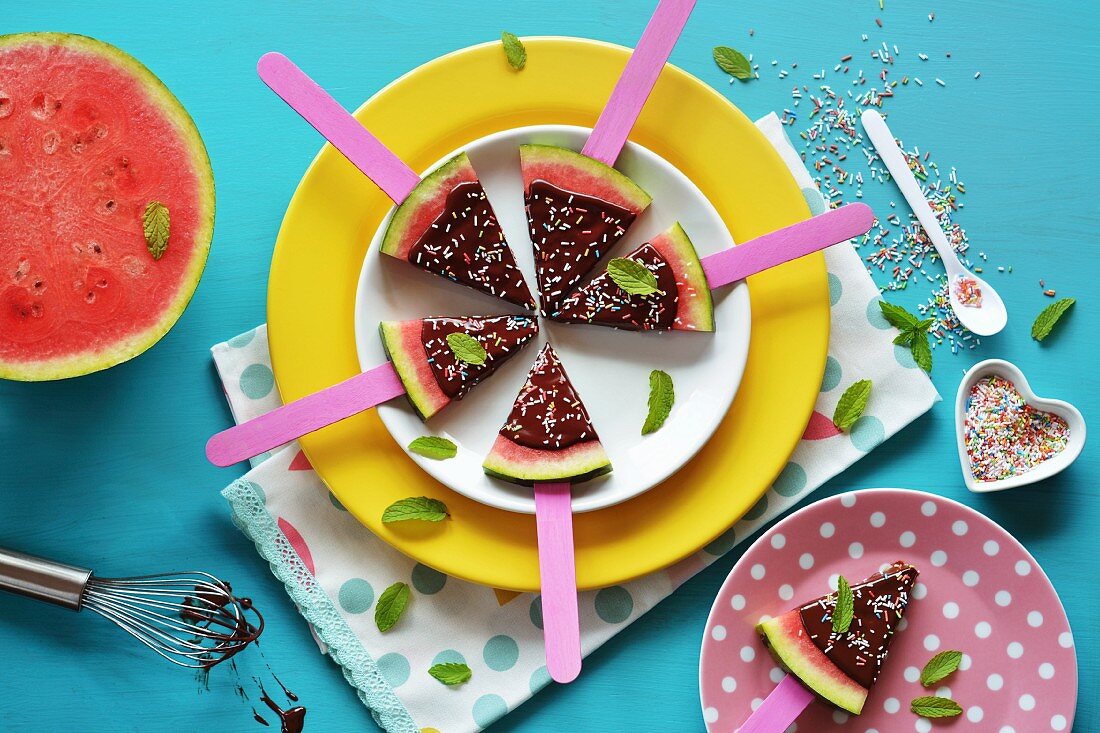Watermelon slices glazed with chocolate and colourful sugar sprinkles