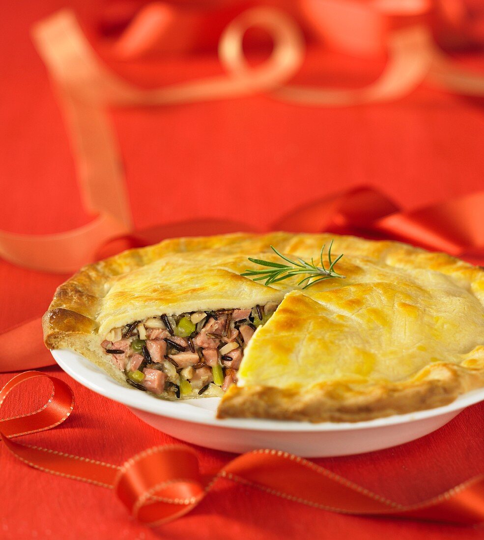 Duck and wild rice pie, with a slice removed