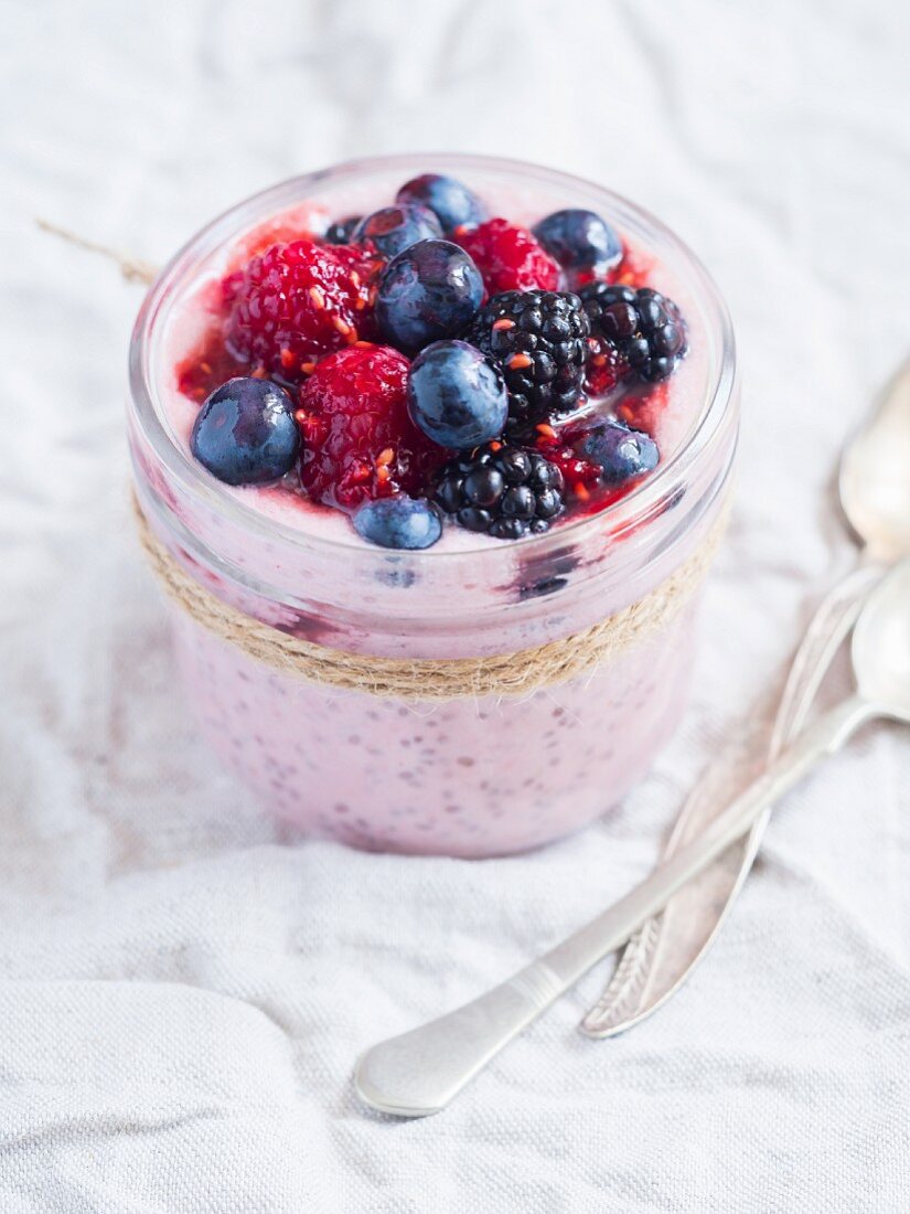 Vegan red chia pudding with coconut milk and summer berries