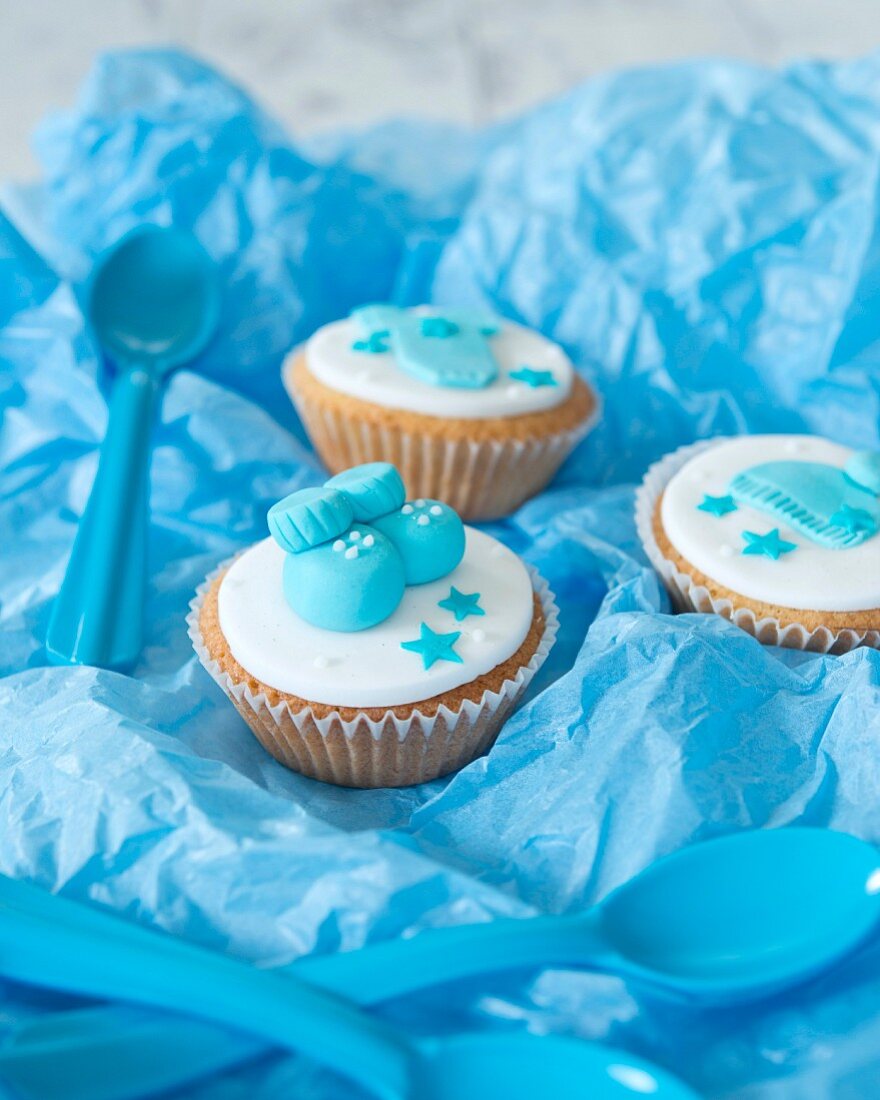 Cupcakes for a baby shower on blue paper