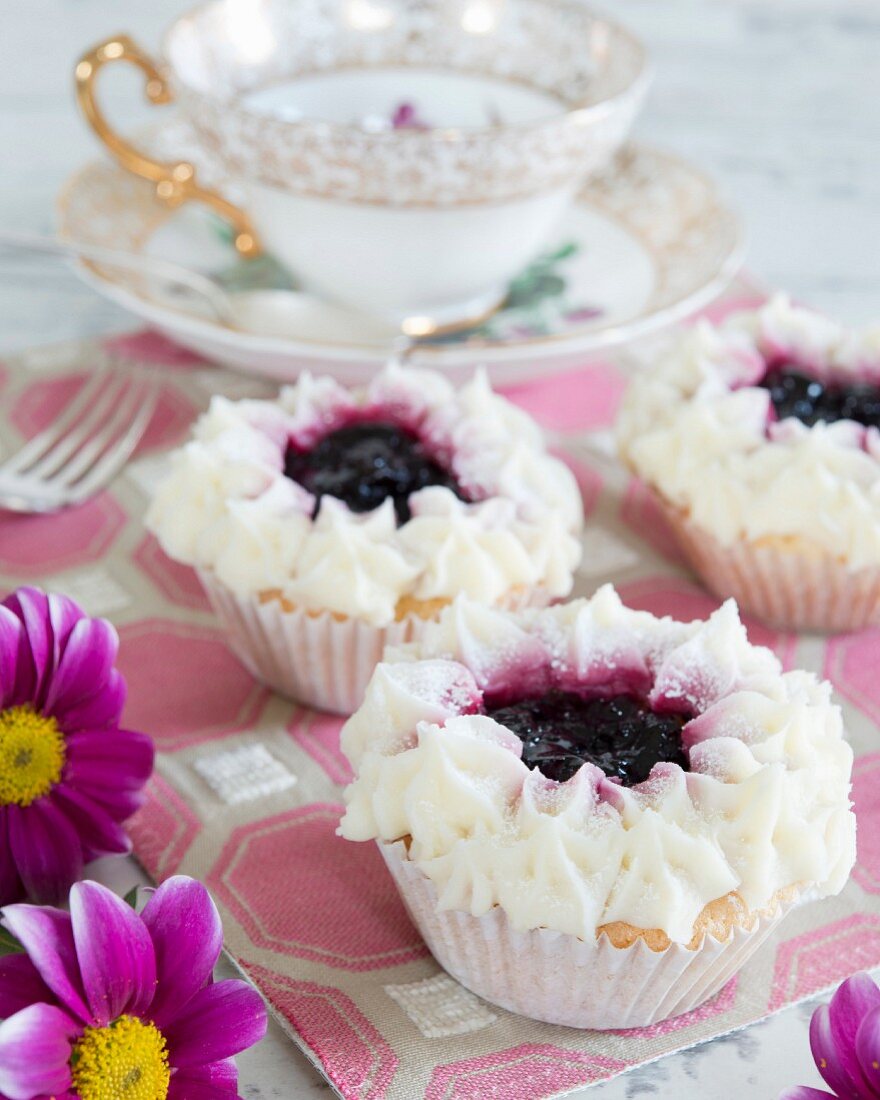 Festive cupcakes topped with jam and cream