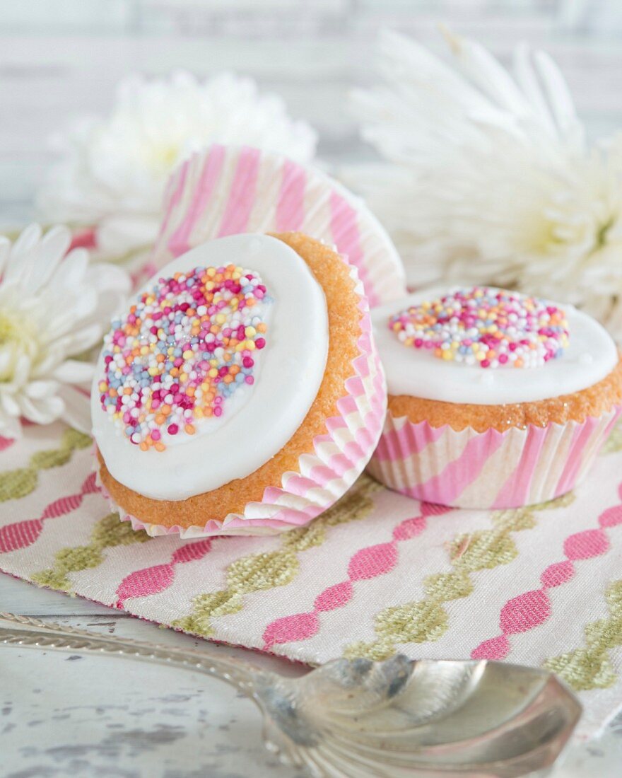Cupcakes decorated with icing and colourful sugar sprinkles