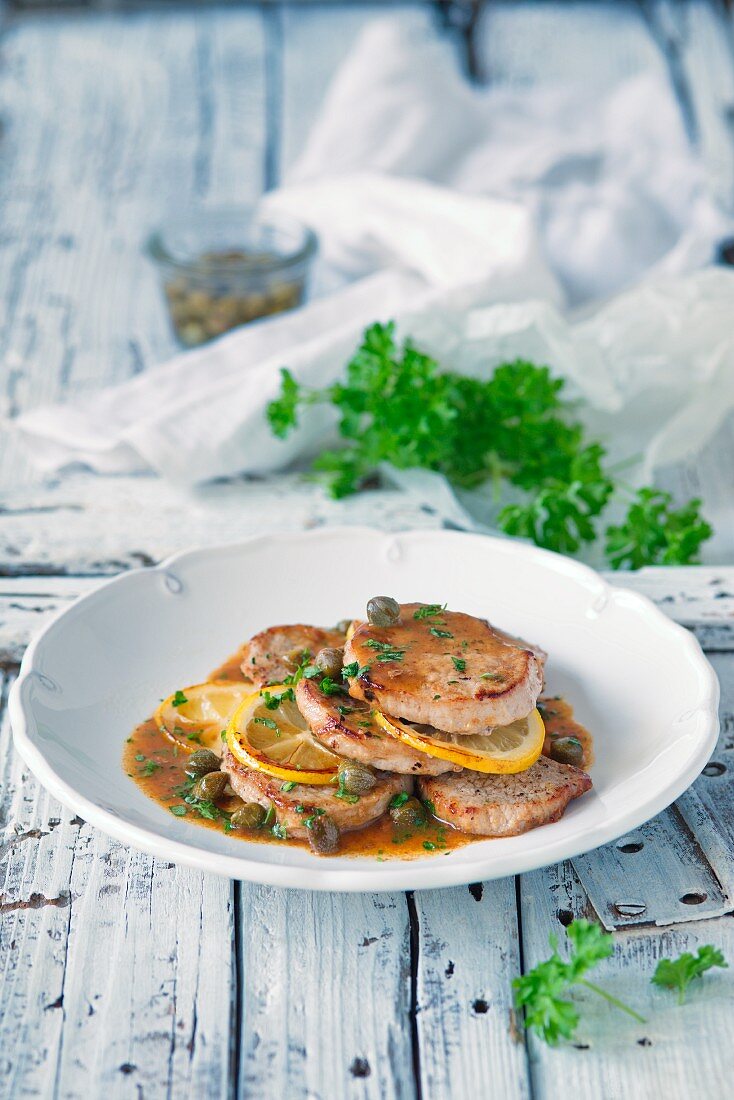 Pork slices with lemons and capers