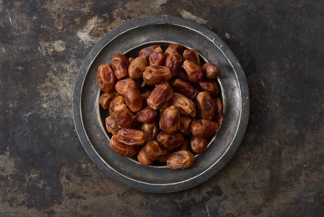 Dried dates on a metal plate
