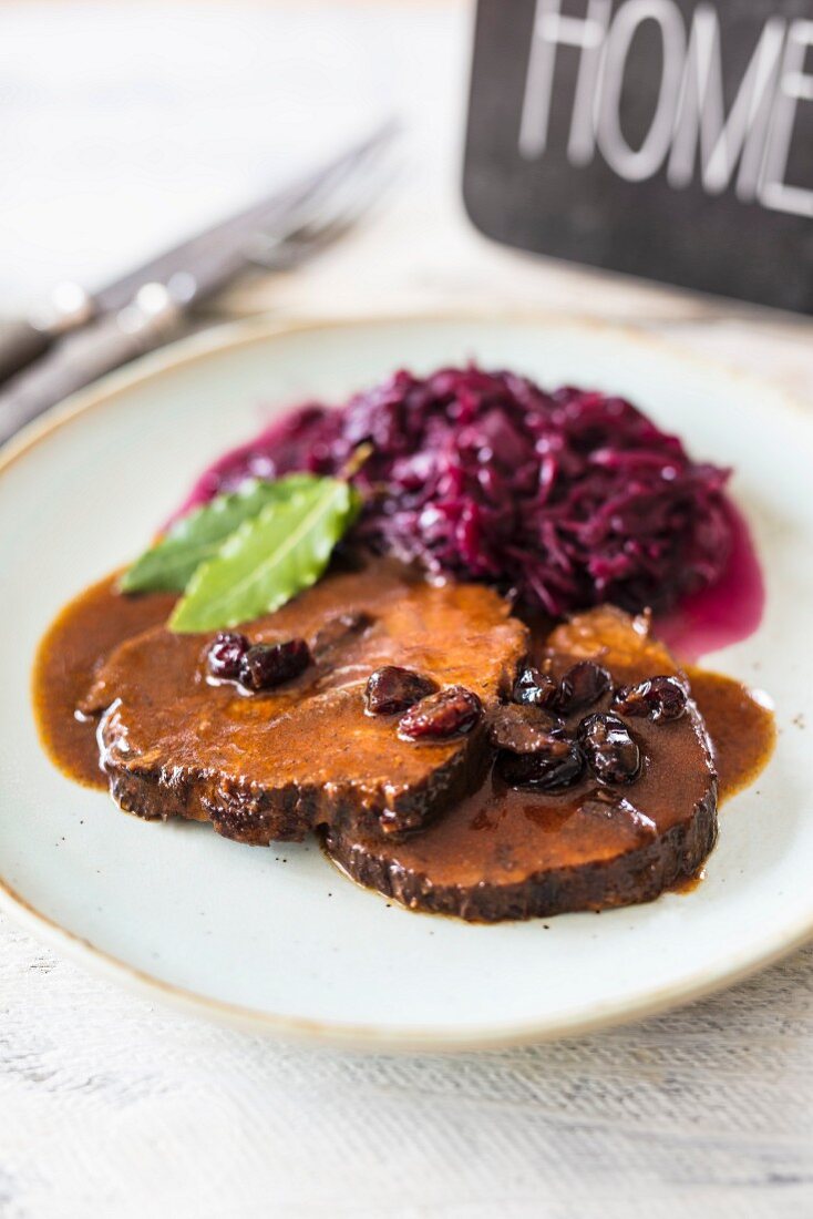 Sauerbraten (marinated pot roast) with cranberries and red cabbage