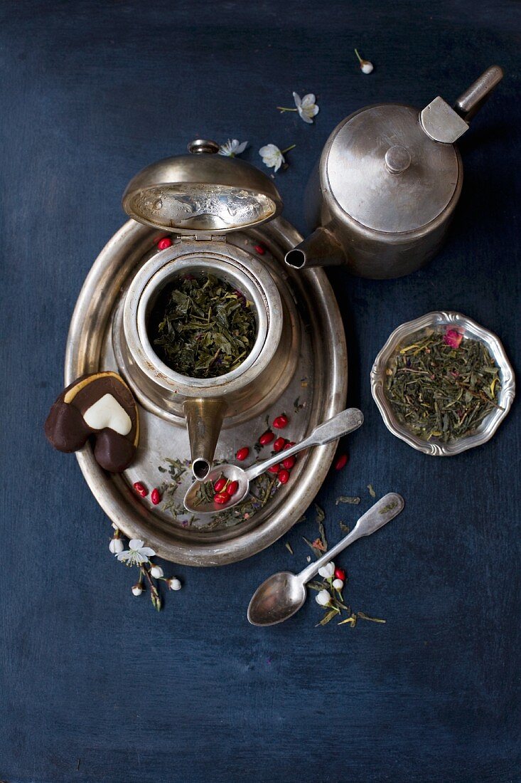 A silver tea set on a blue background