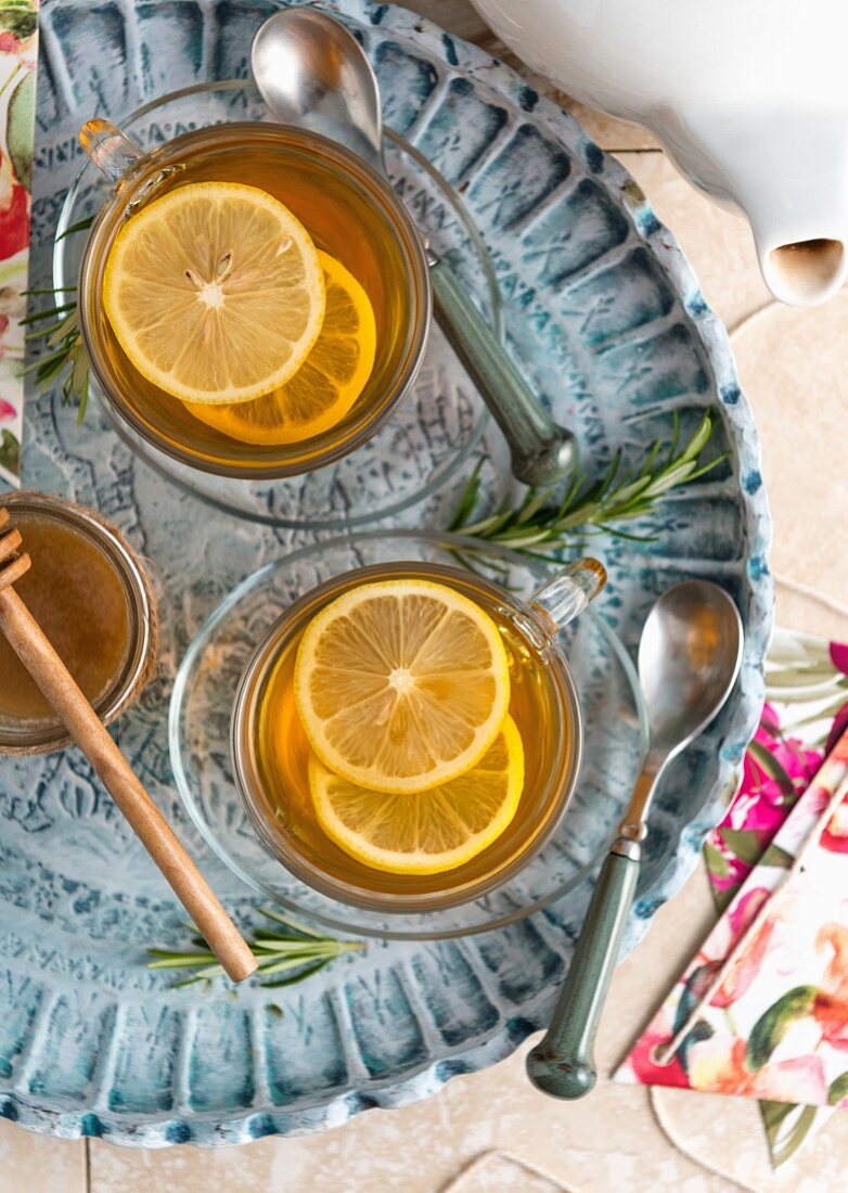 Lemon and rosemary tea in teacups