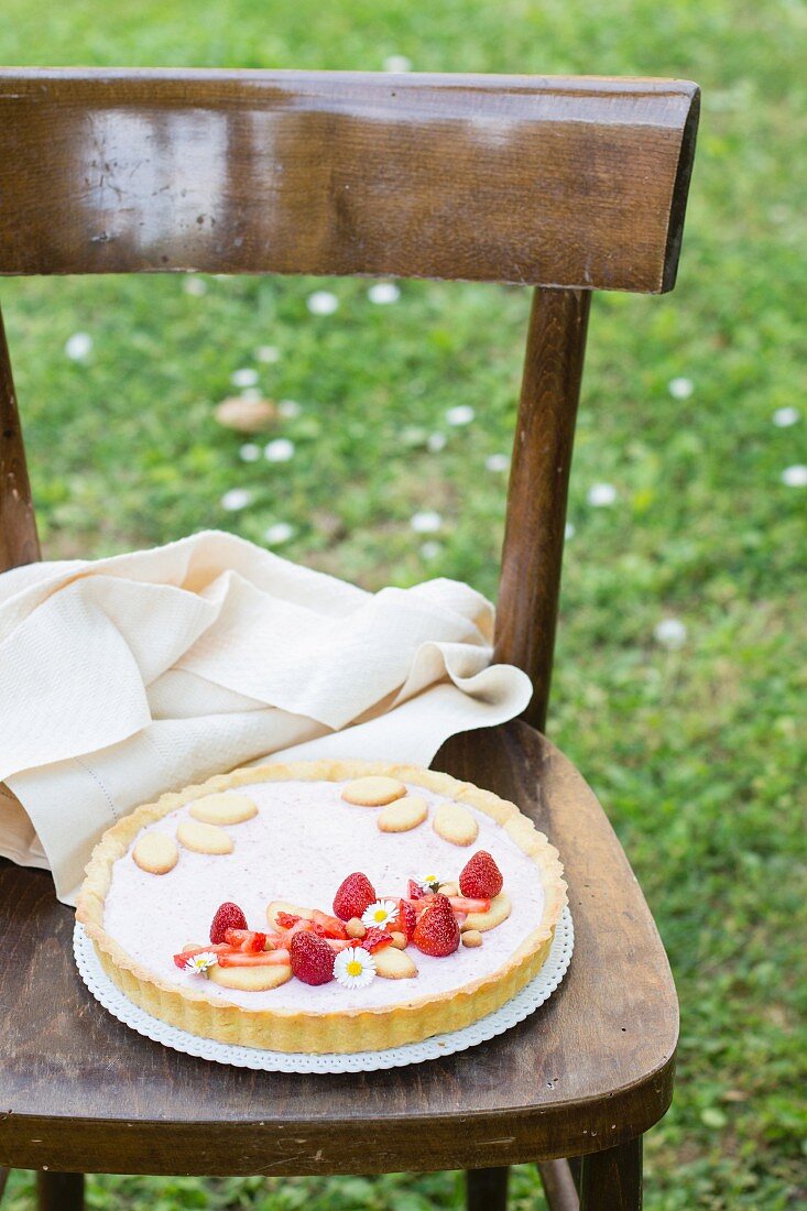 A strawberry tart on a garden chair