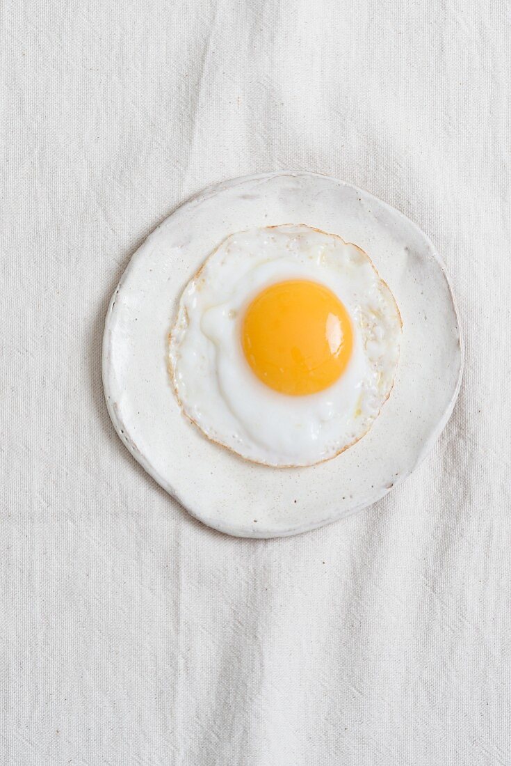 Fried egg on a white plate