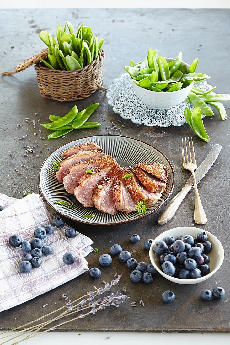 Duck breast with lavender oil, sugar snap peas and blueberries