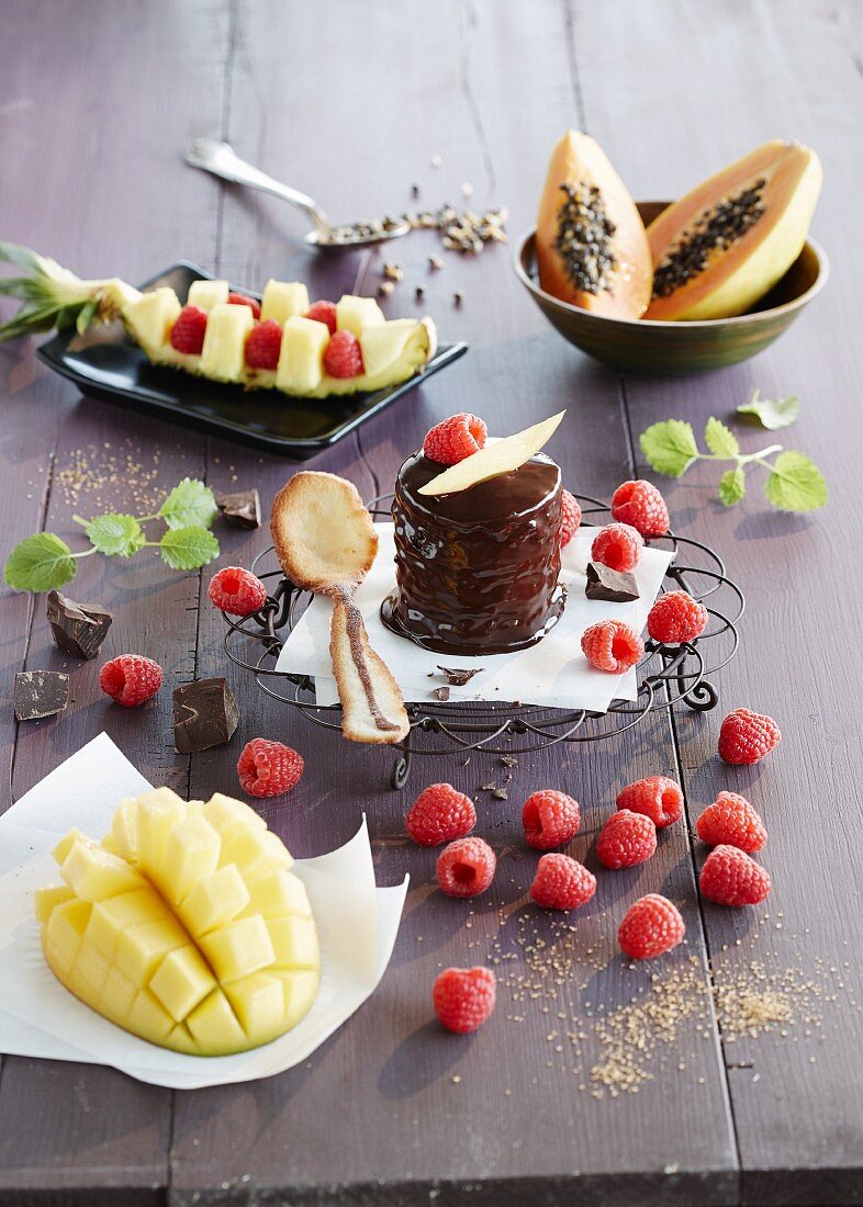 A chocolate cake with raspberries and exotic fruits