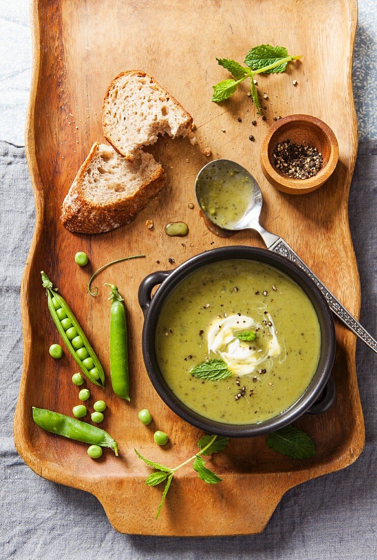 Pea soup with cream, black pepper and fresh mint leaves