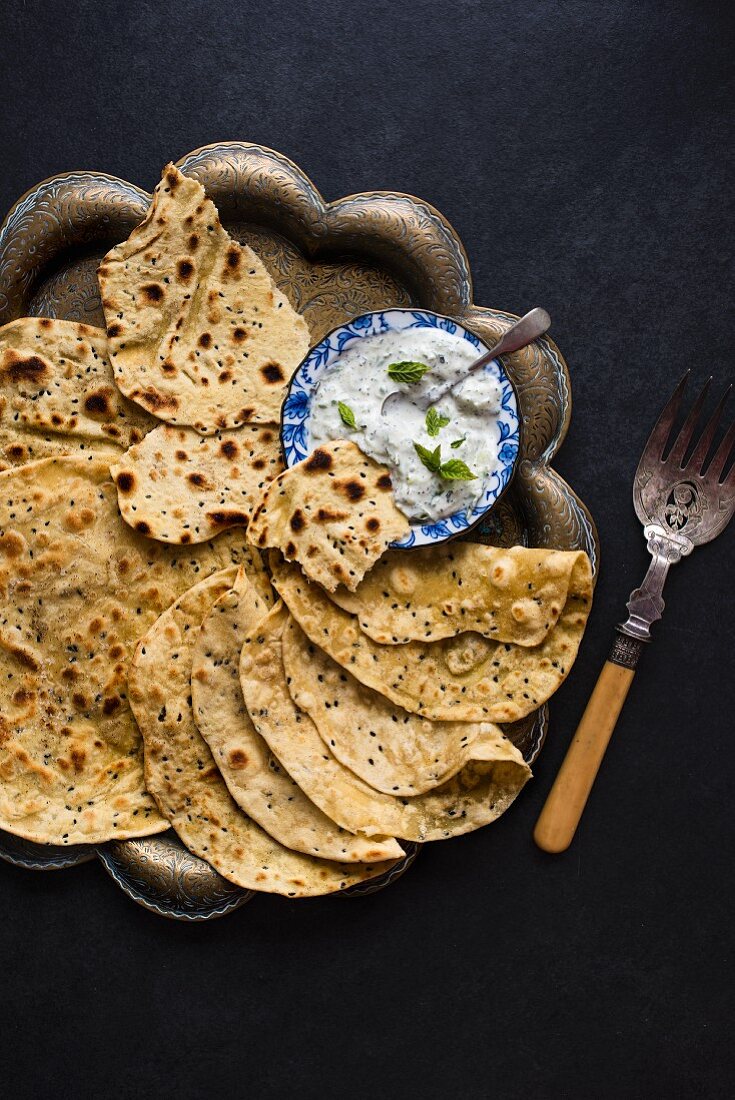 Flatbread with black onion seeds and cucumber raita