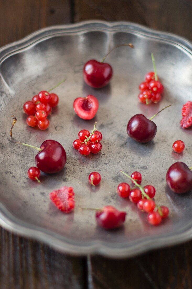 Berries and cherries in a metal bowl