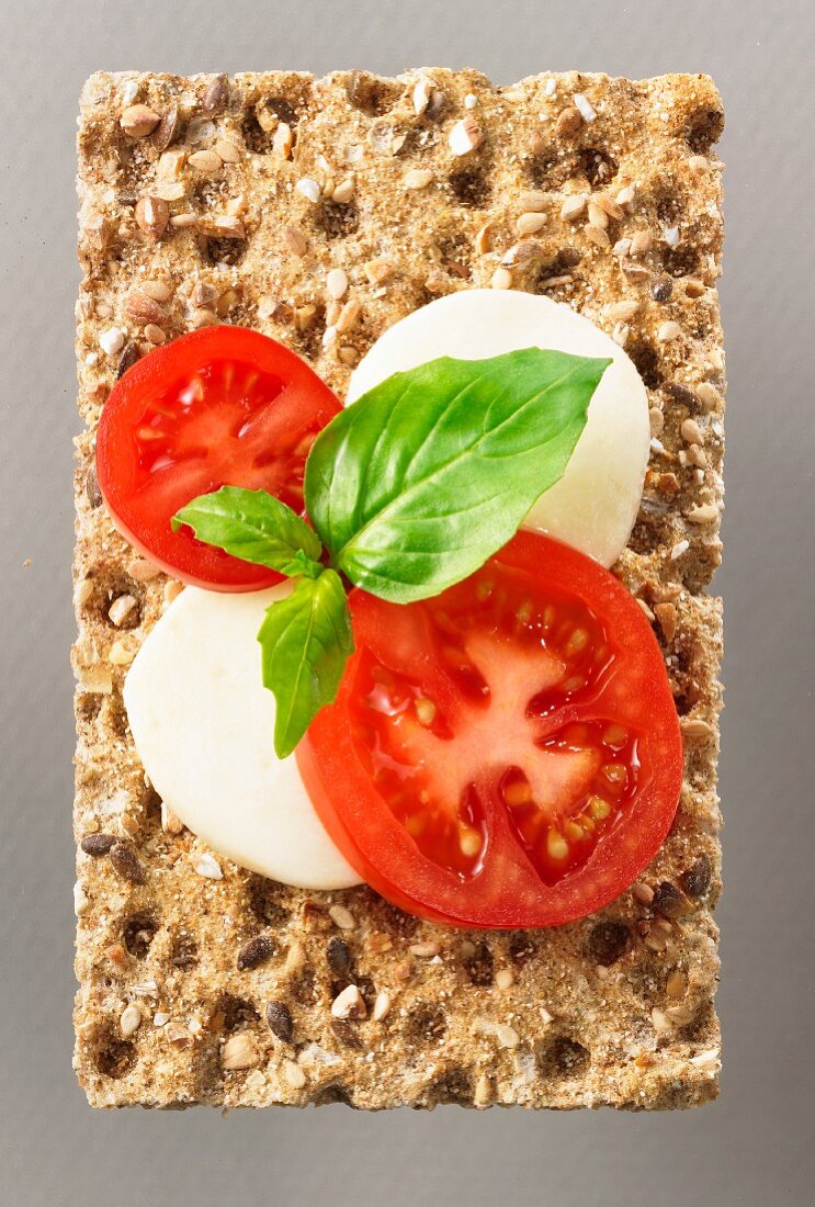 Tomato mozzarella basil on multigrain crisp