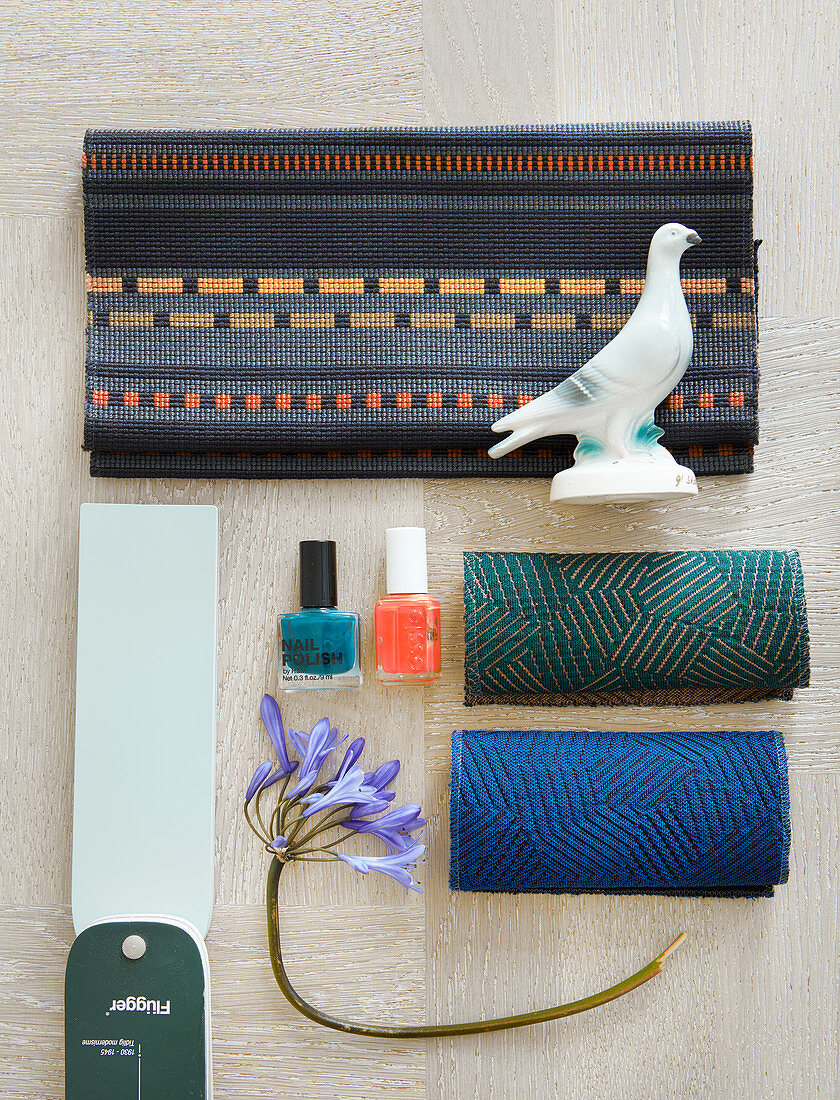 Mood board with fabric swatches, nail polishes, flower and bird figurine