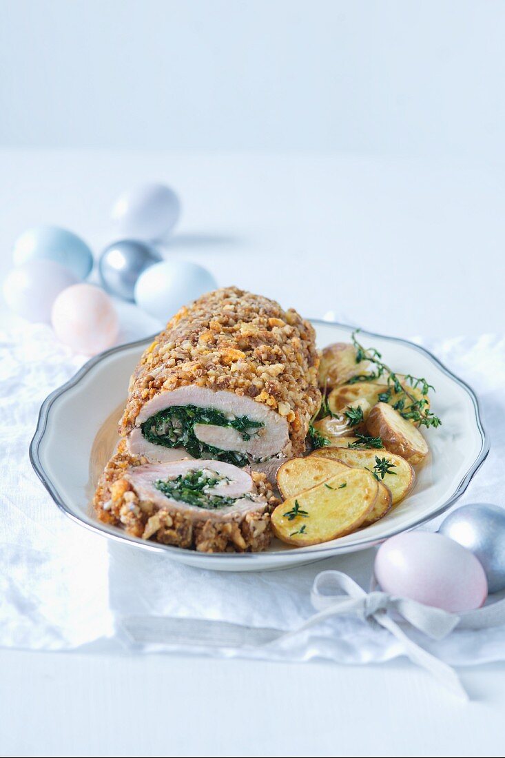 A veal roll filled with spinach and served with fried potatoes at Easter