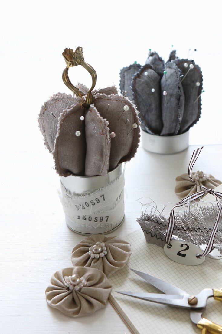 Hand-sewn cactus pin cushions made from grey fabric