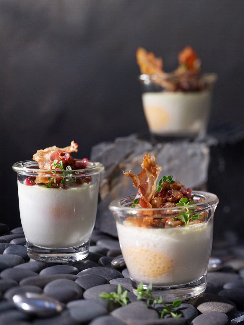 Poached eggs in glasses with oyster mushrooms, spring onions and pancetta