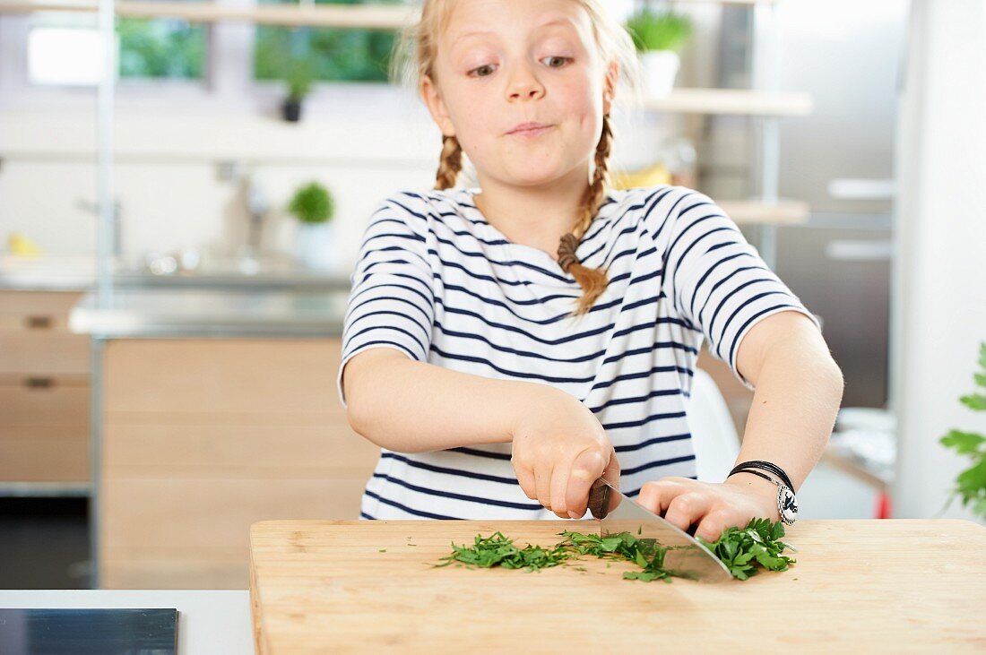 A girl chopping fresh parsley