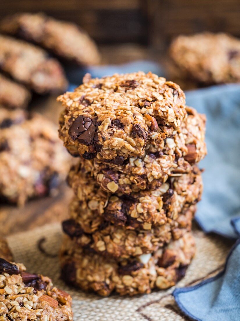 Vegan chocolate chip oatmeal cookies arranged in a pile