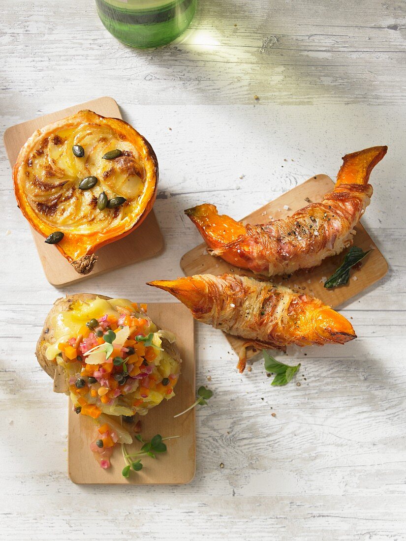 Stuffed pumpkins and potatoes on wooden boards