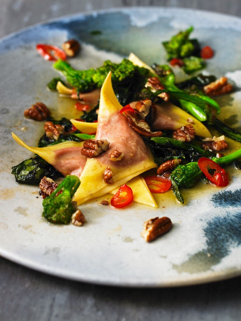 Beetroot ravioli with chillies, scamorza, broccoli rabe and pecan nuts