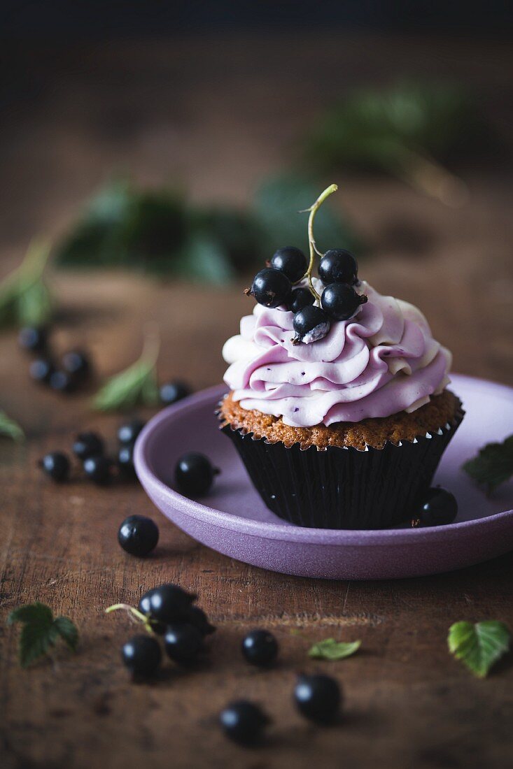 Blackcurrant and white chocolate cupcake on a plate