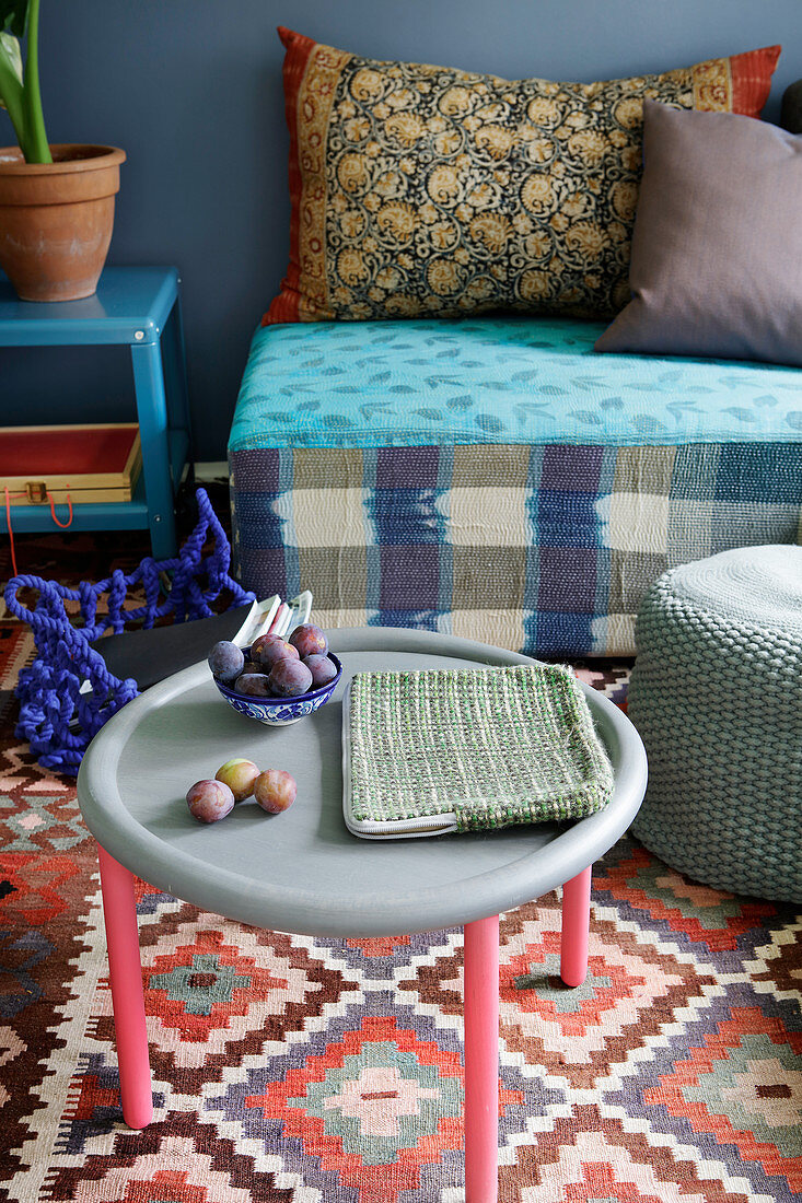 Grey table with pink legs in living room