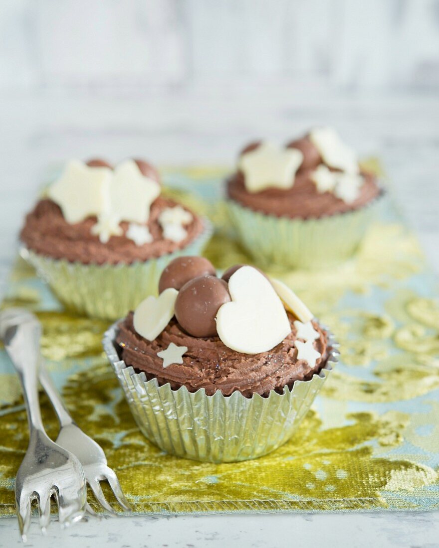 Cupcakes with chocolate candies, hearts and stars