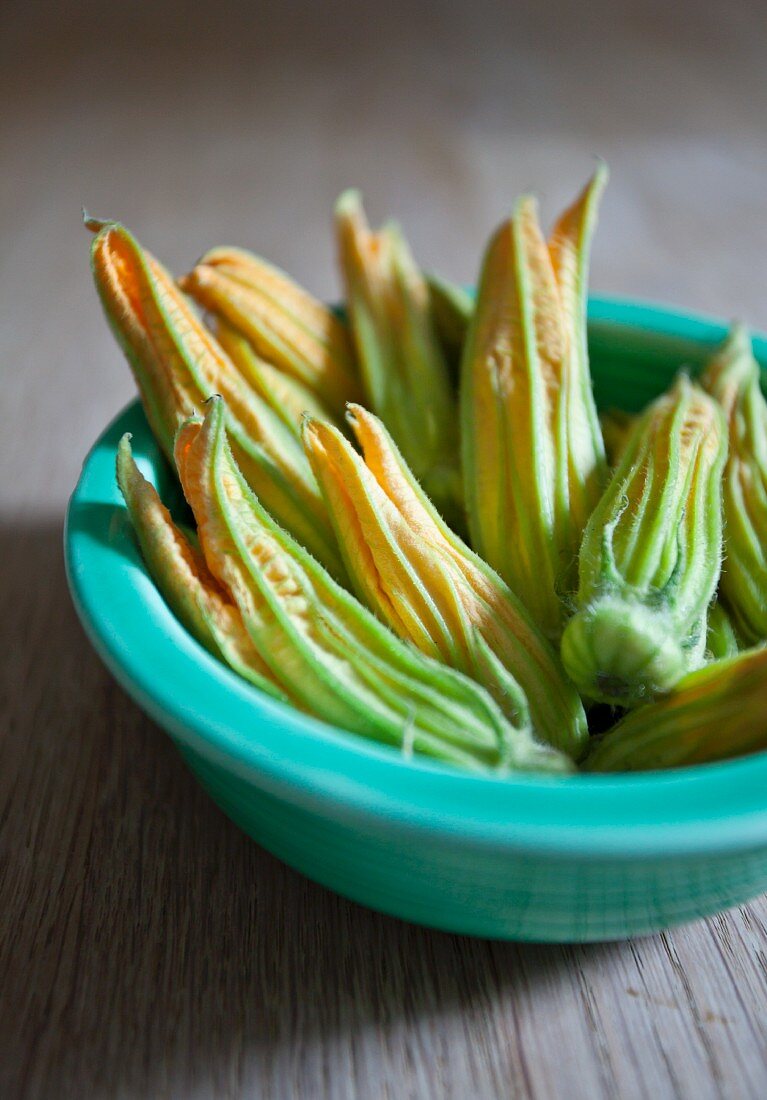 Zucchini flowers in a green bowl