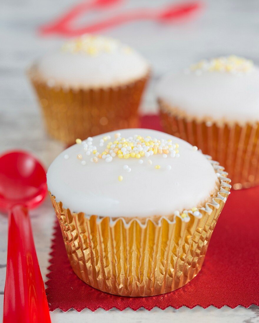 Cupcakes with fondant icing and sugar beads on the top