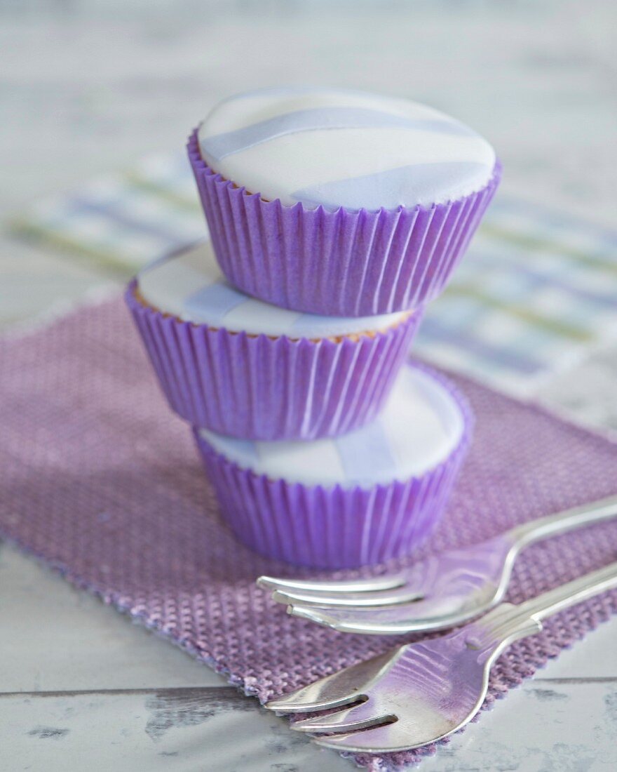 Stacked cupcakes with striped fondant icing