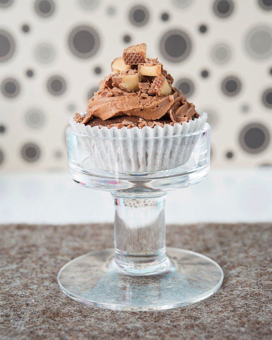 A cupcake with chocolate cream frosting