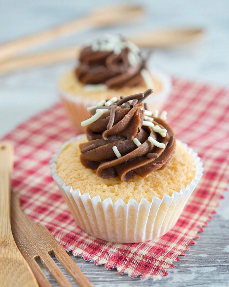 Cupcakes with chocolate cream and sprinkles on the top
