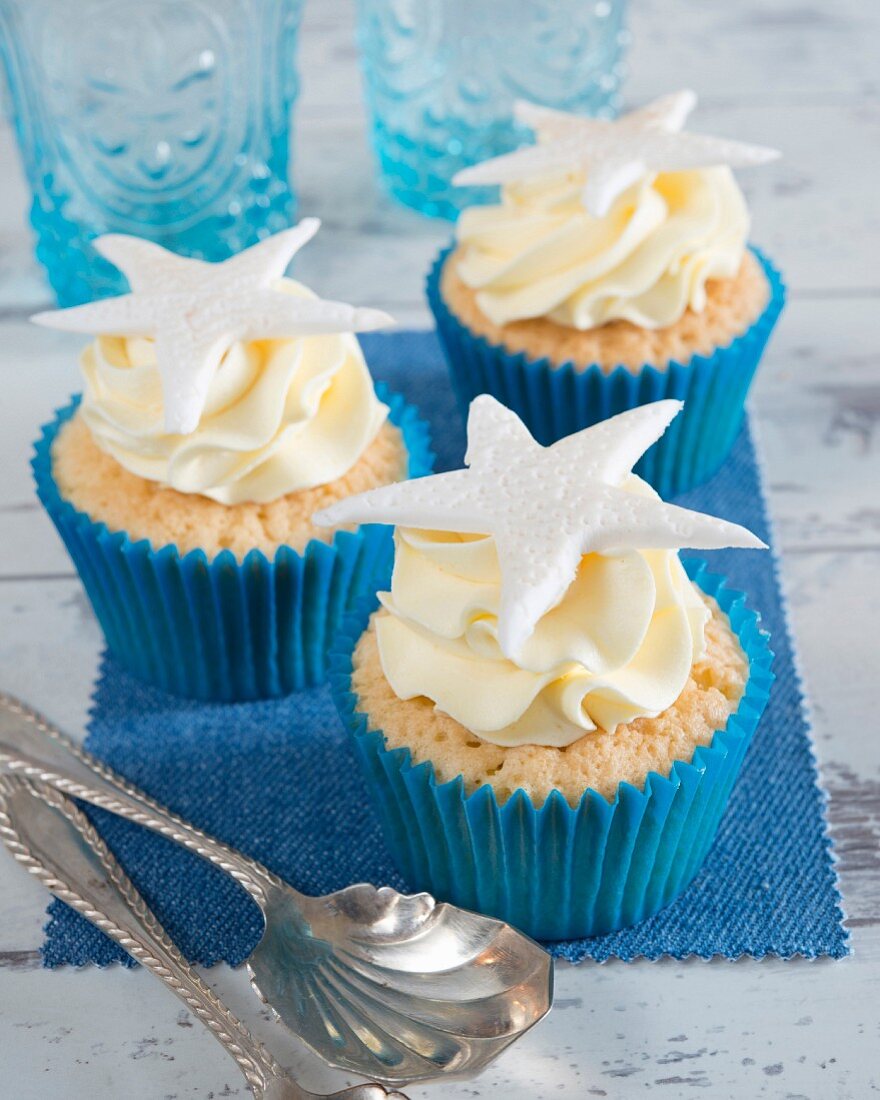 Cupcakes with cream and a starfish on the top