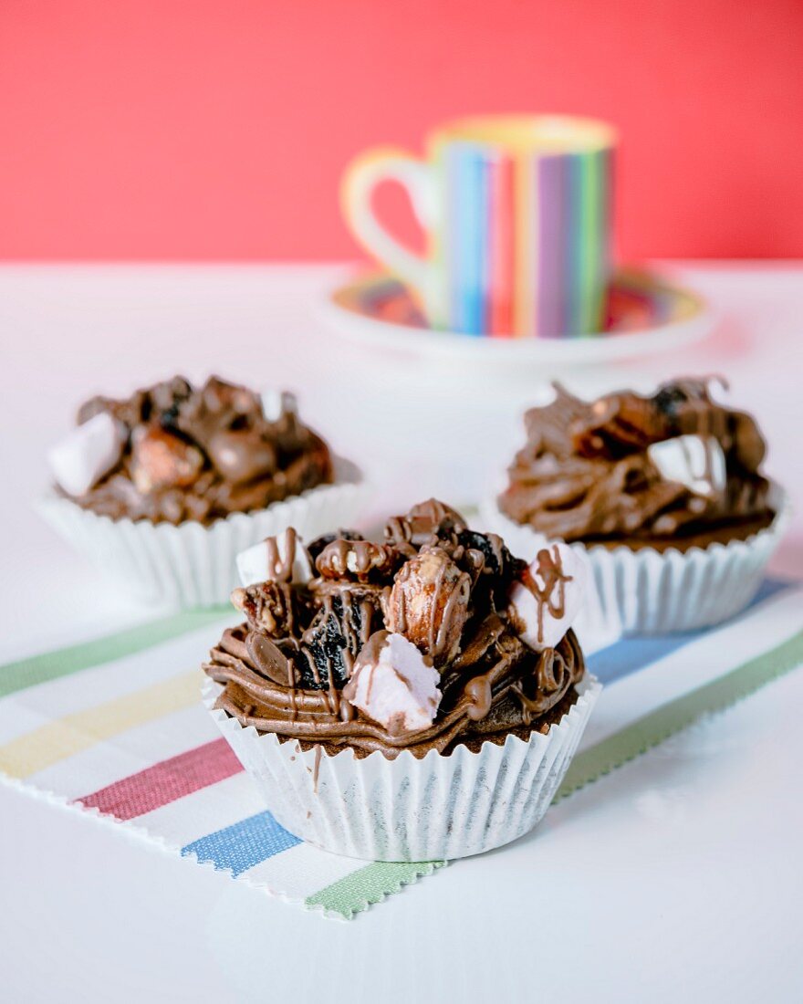 Cupcakes with chocolate cream, almonds and marshmallows