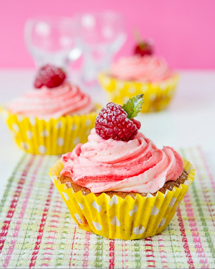 Cupcakes with raspberry cream and raspberries