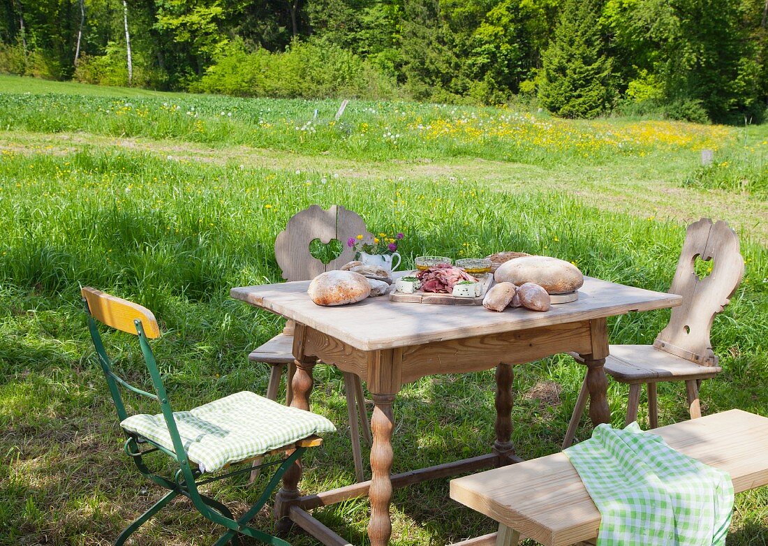 Brotzeit served on a rustic table in a garden