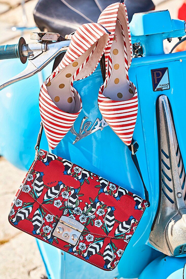 Red and white striped shoes and a leather shoulder bag